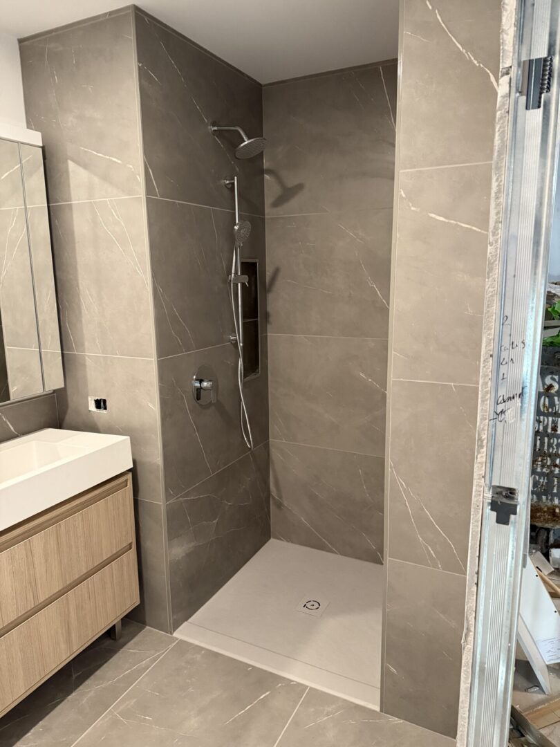 A bathroom with a shower and sink in it