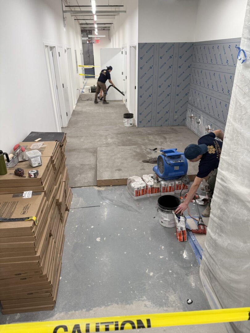 A couple of men are working in the hallway
