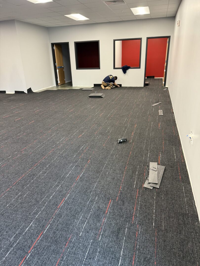 A room with carpet and red doors