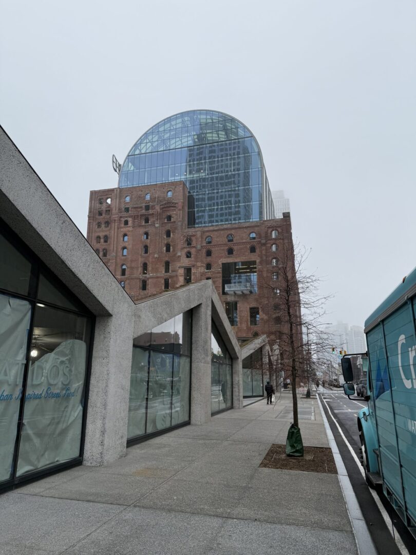 A building with a large glass tower in the background.